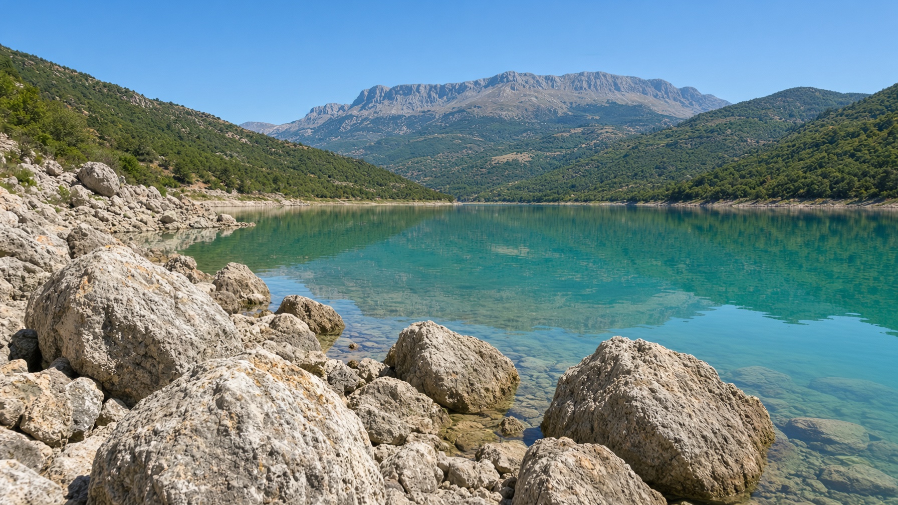 The lake holding Gallo Matese on a still evening