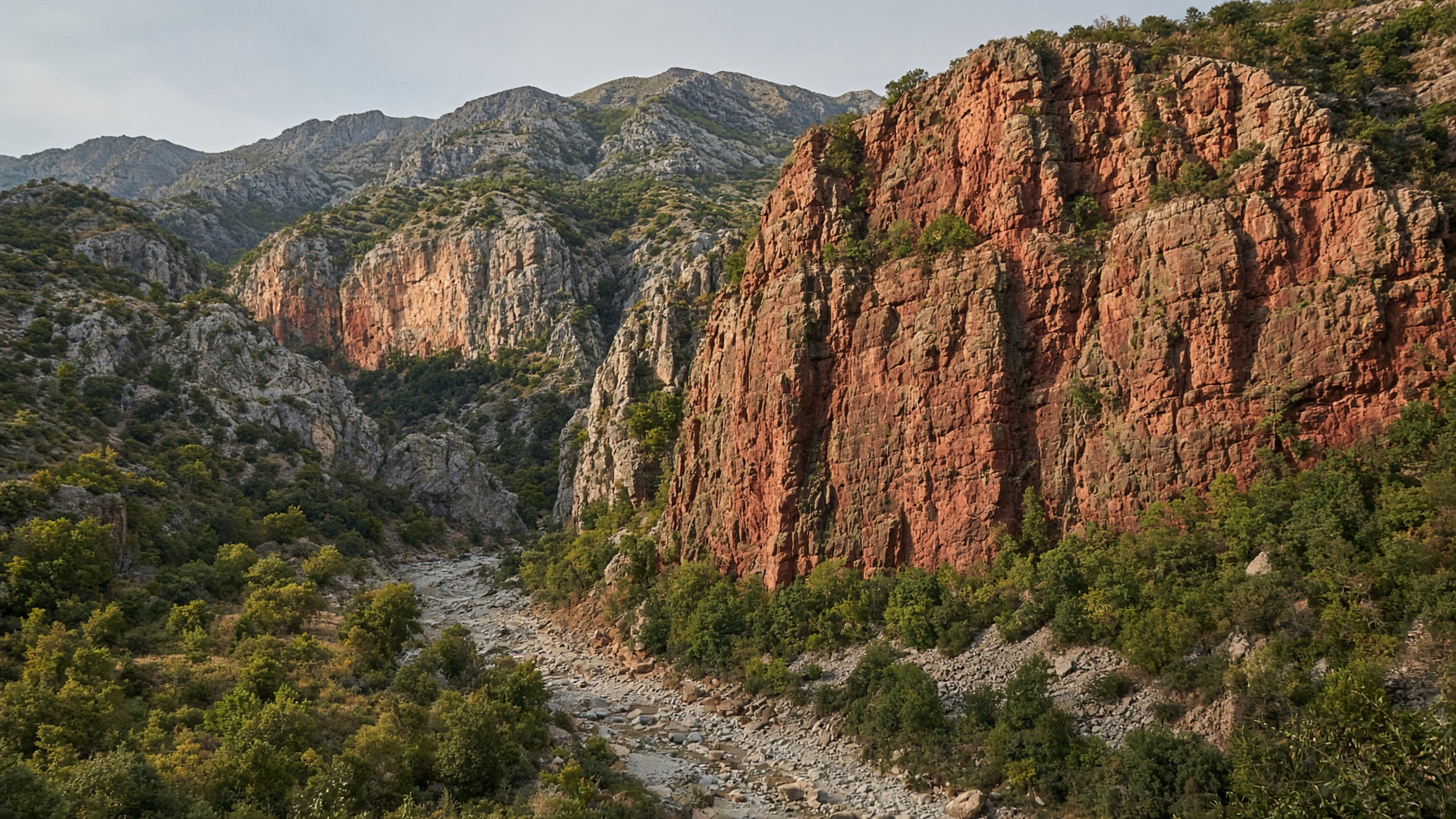 Sheer limestone cliff over a green gorge